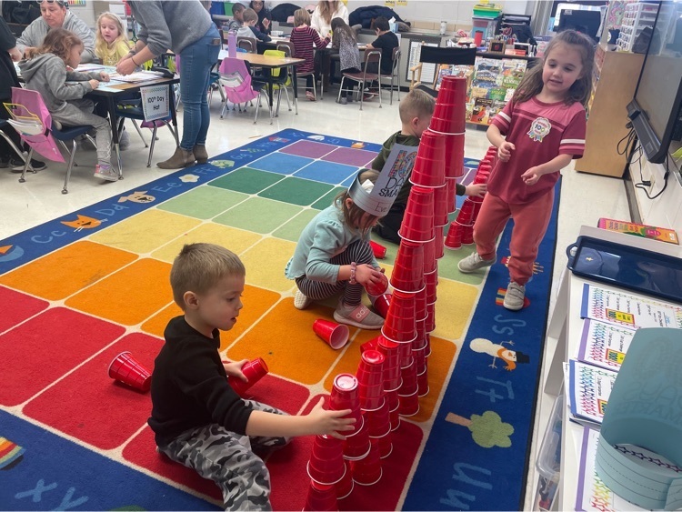 student stacking 100 cups