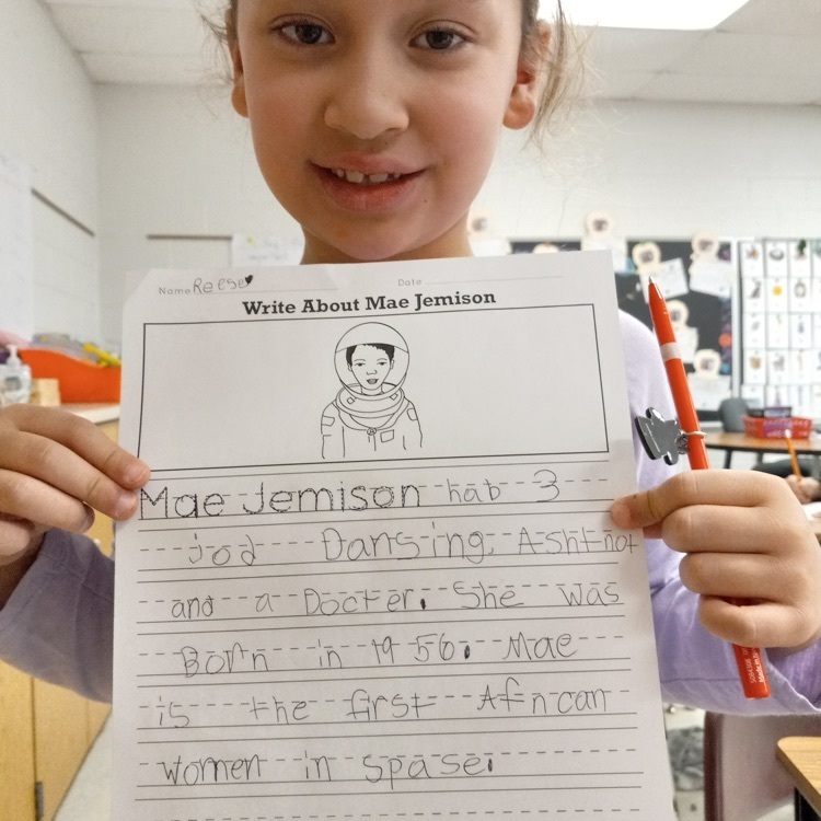 student showing off her writing 